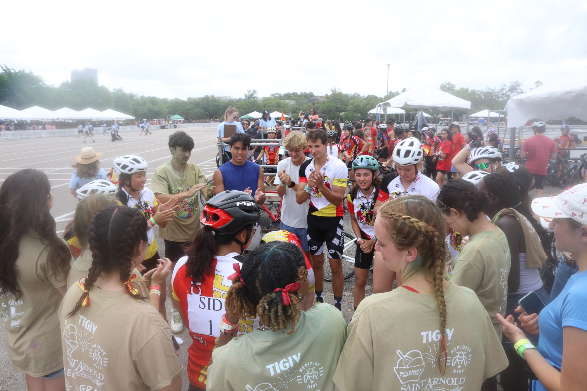 sid richardson bikers and spectators huddled together at the beer bike race track