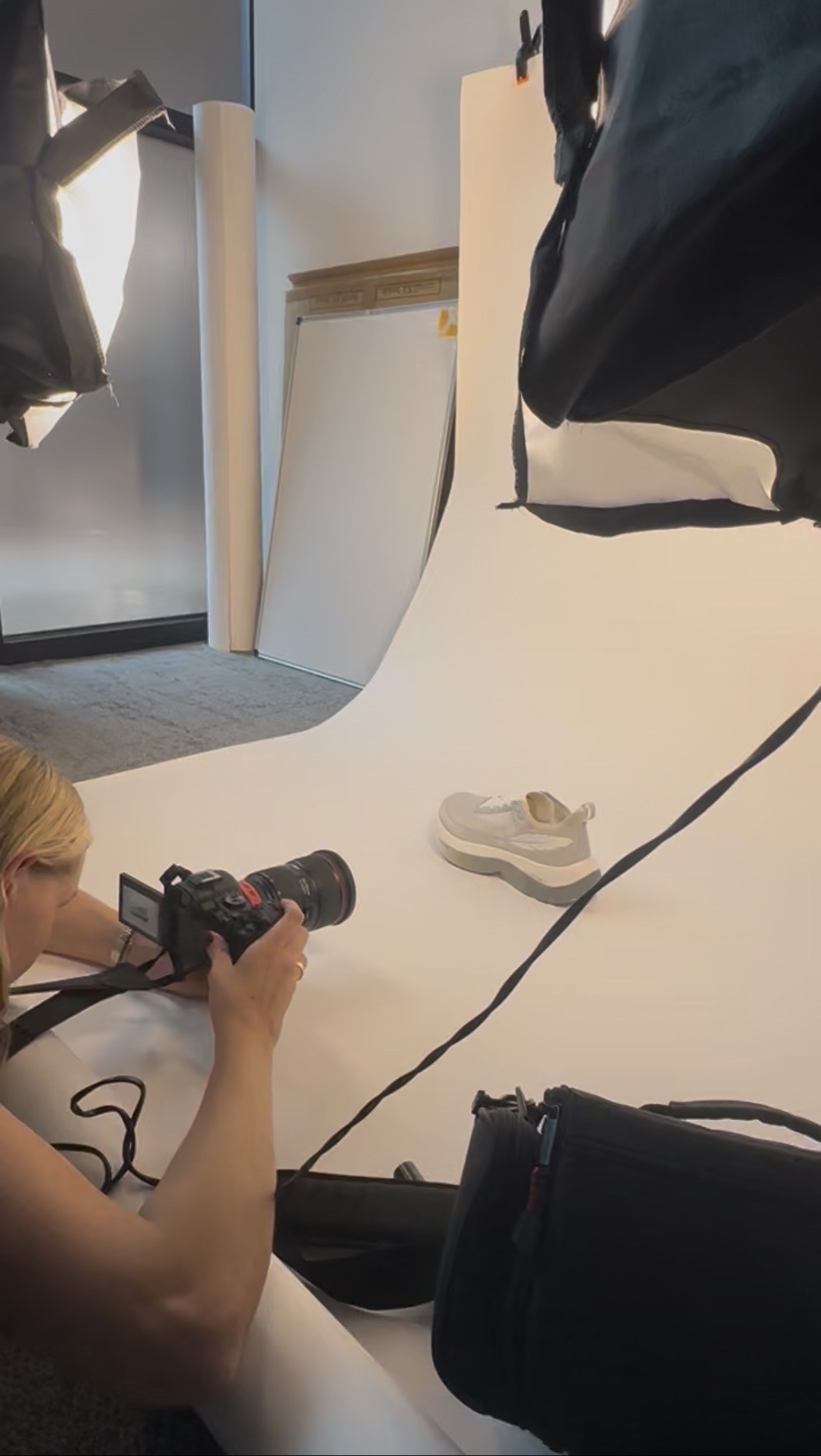 shooting the campaign product photography on a white sweep in the studio